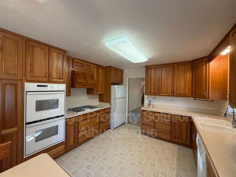 4-bedroom 3-bath home at 7121 Edwina Ave NE for $2,450/mo managed by Brickleys Property Solutions Albuquerque — photo 11 of 47