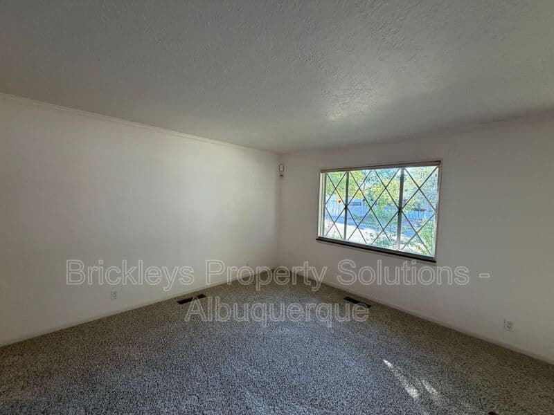 4-bedroom 3-bath home at 7121 Edwina Ave NE for $2,450/mo managed by Brickleys Property Solutions Albuquerque — photo 8 of 47