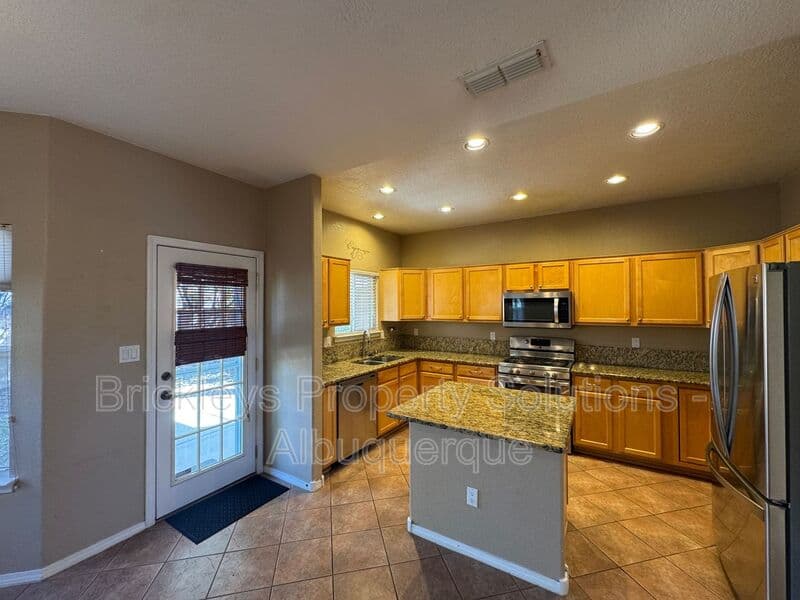 4-bedroom 3-bath home at 7131 Wild Olive Ave NE for $2,900/mo managed by Brickleys Property Solutions Albuquerque — photo 9 of 38