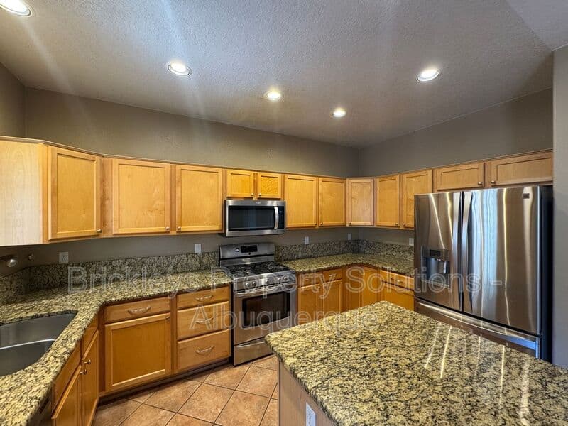 4-bedroom 3-bath home at 7131 Wild Olive Ave NE for $2,900/mo managed by Brickleys Property Solutions Albuquerque — photo 10 of 38