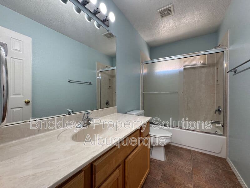 4-bedroom 3-bath home at 7131 Wild Olive Ave NE for $2,900/mo managed by Brickleys Property Solutions Albuquerque — photo 23 of 38