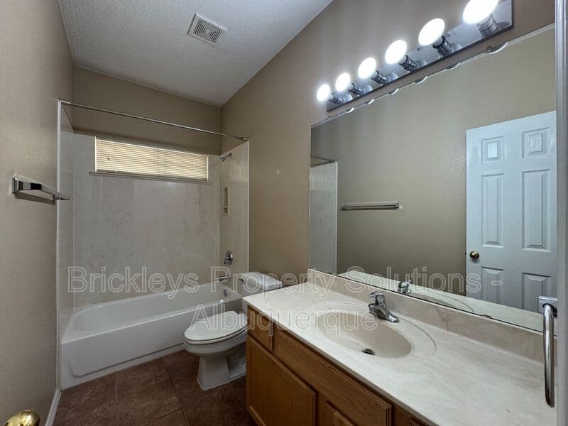 4-bedroom 3-bath home at 7131 Wild Olive Ave NE for $2,900/mo managed by Brickleys Property Solutions Albuquerque — photo 16 of 38